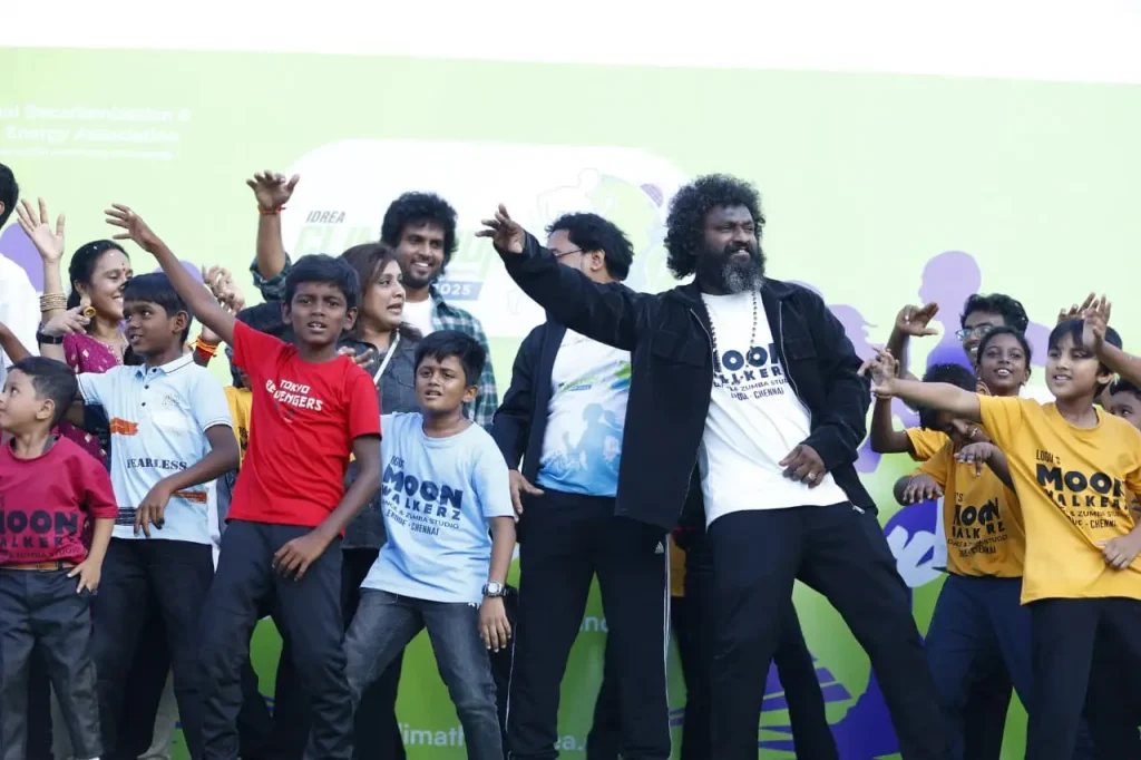 Group performing on stage energetically.